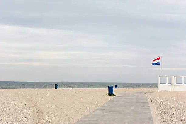 Beach Hook of Holland before the Holidays with the dutch national Flag