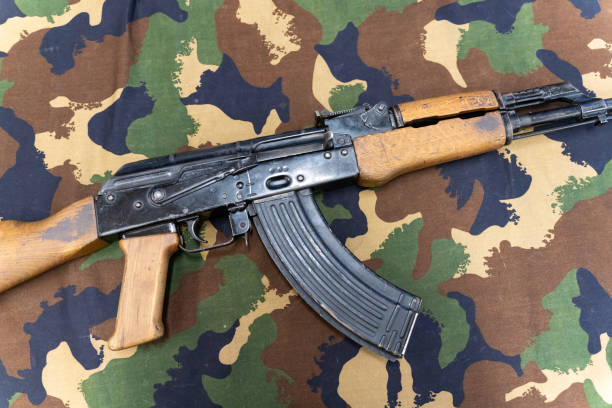 istock AK-47 Kalashnikov assault rifle on a camouflage tarp 1808410570