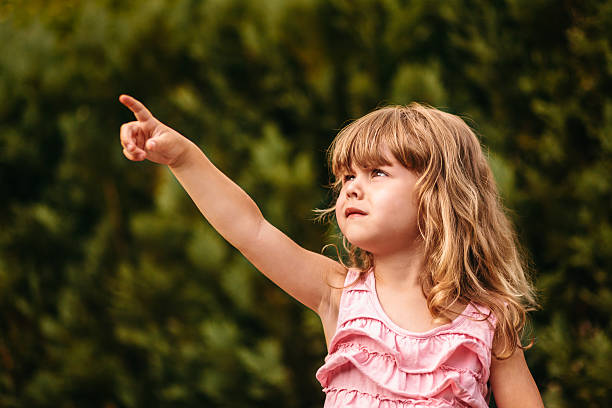 istock Little girl pointing at copy space 180841242