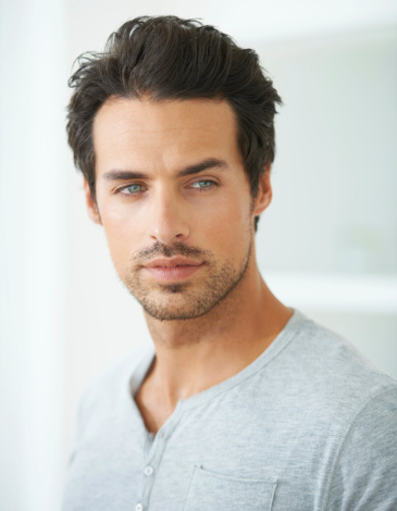 Head and shoulder shot of a handsome young man looking away