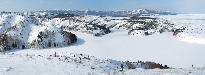 Winter lake under ice and snow among the hills, Sakhalin island