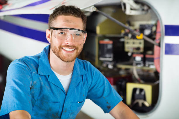istock Mechanic working on private jet in airplane hangar 180841705