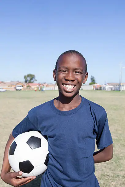 "Portrait of  Teenage Boy Holding Soccerball, Gugulethu, Cape Town, South Africa."