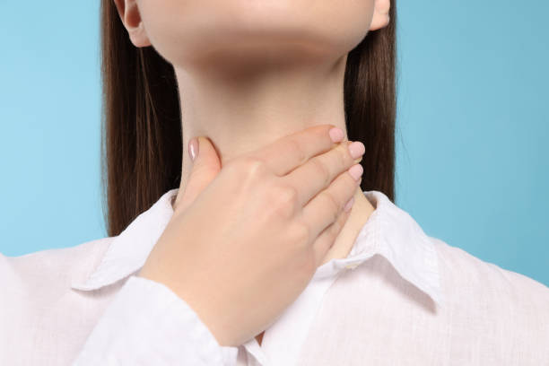 istock Woman with sore throat on light blue background, closeup 1808419737