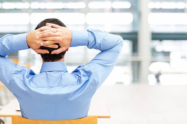 istock Businessman Relaxing With Hands Behind Head 180842563
