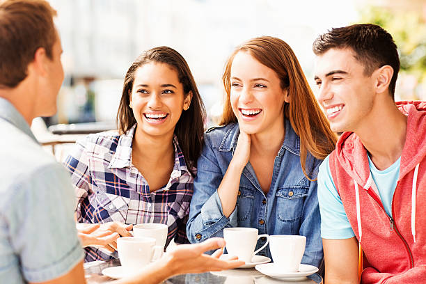 istock Teenage Friends Having A Discussion While Drinking Coffee At Cafe 180843168