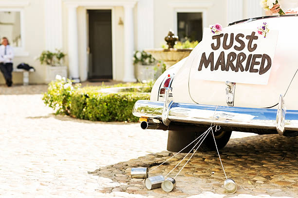 just married sign and cans attached to car - nygift bildbanksfoton och bilder