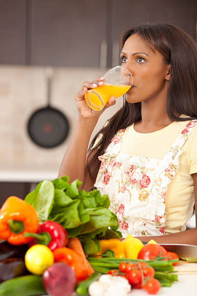 Housewife drinking juice in the kitchen.