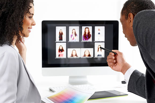 istock Young woman learning photo editing in office 180844019