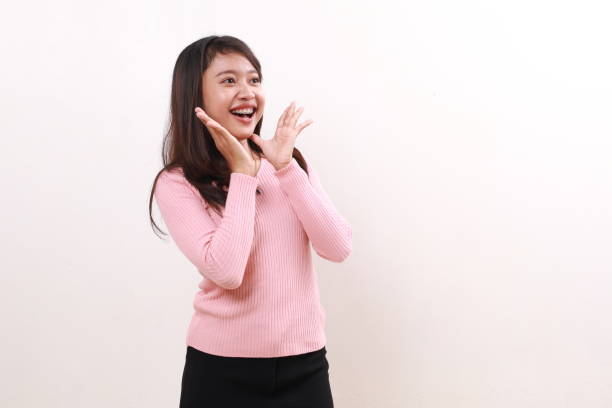 istock Wow excited amazed expression of young asian girl standing while looking sideways on empty space. Isolated on white background 1808440822