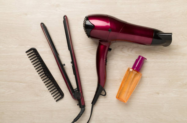 Hair tools with thermo protection on wooden background, top, view
