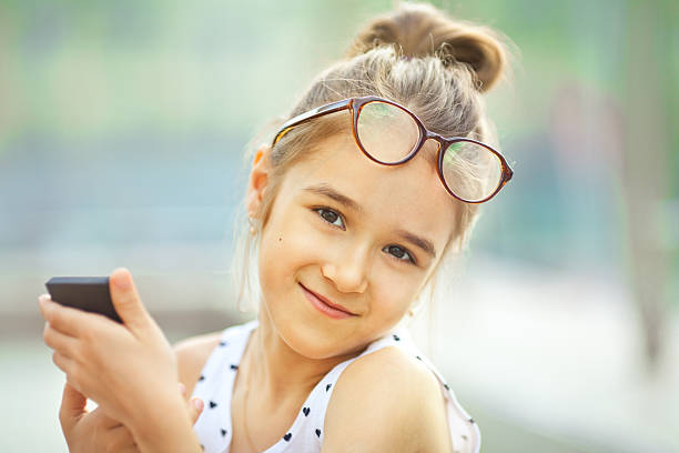 istock Sunny girl Text Messaging on cell phone 180844235