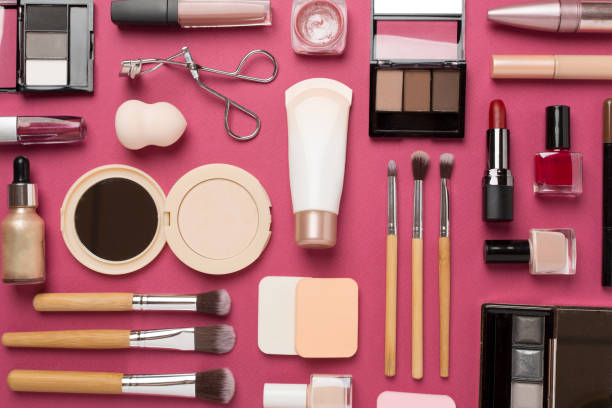 istock Flat lay with makeup products and tools on color background 1808447639