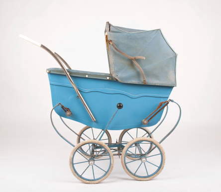 An very old baby carrige on white background