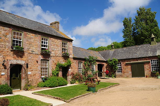 istock A farmhouse with a lawn and driveway 180845610
