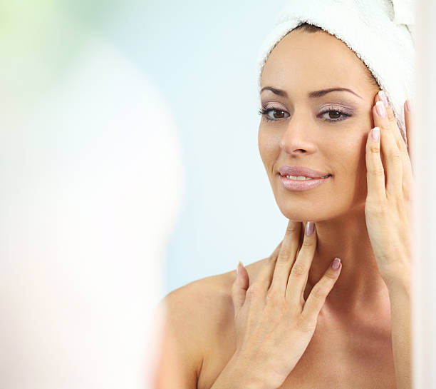 istock Attractive brunette examining her skin 180845982