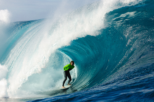 A young male surfer standing in the tube of a powerful breaking wave.This image is part of the Amazing Waves collection.