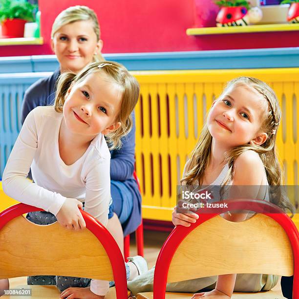 Cute Girls In A Nursery School Stock Photo - Download Image Now - 4-5 Years, Adult, Cheerful