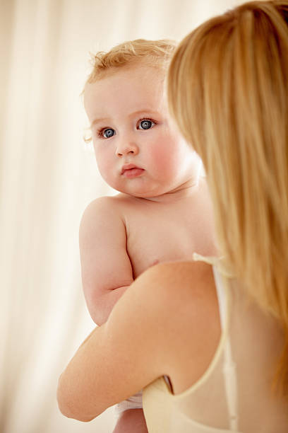 istock Safe in his mother's arms 180846248