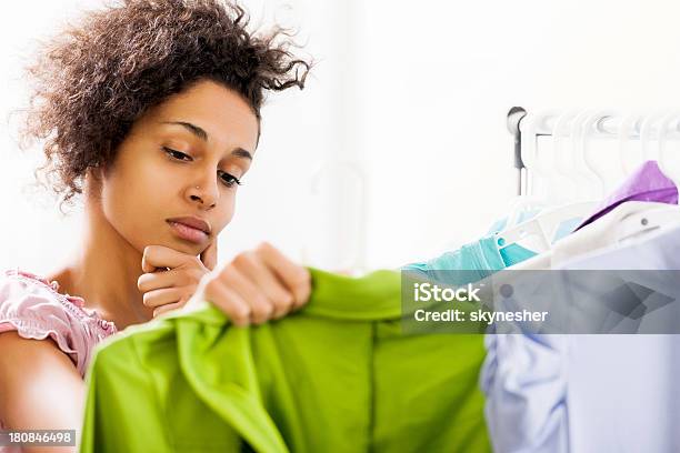 Young Woman Thinking What To Buy Stock Photo - Download Image Now - Clothing Store, Adult, Adults Only