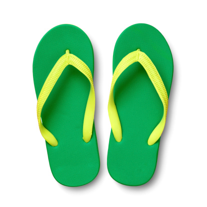 A pair of green flip flops on white background