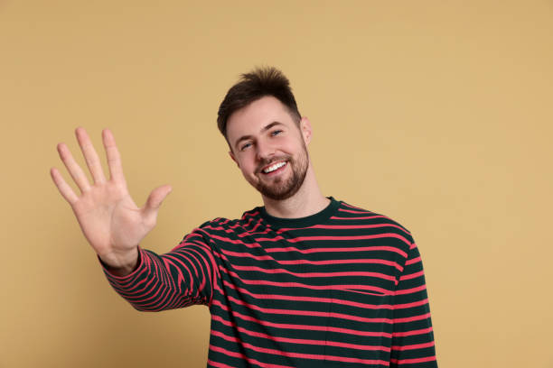 istock Man giving high five on beige background 1808468100