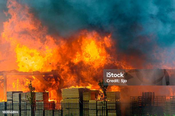 Factory Burning In Industrial Area Stock Photo - Download Image Now - Fire - Natural Phenomenon, Construction Industry, Building Exterior