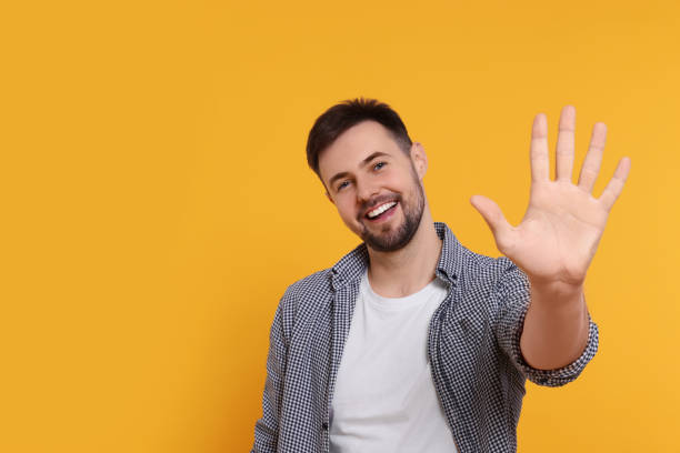 istock Man giving high five on yellow background. Space for text 1808469763