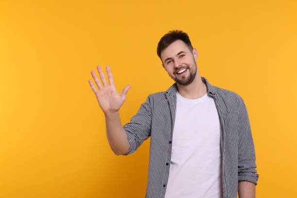 istock Man giving high five on yellow background. Space for text 1808469802