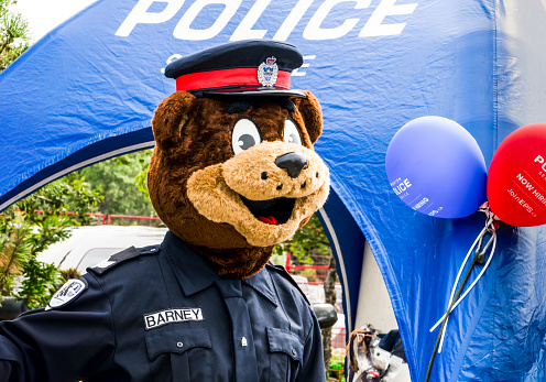 Edmonton, Canada, August 6, 2023: Edmonton police service moscot Barney the Safety Bear at a promotion and hiring booth on Heritage festival in 2023 summer