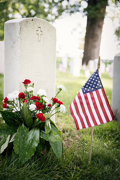 istock Flowers and Flag at a Soldier's Grave 180847334