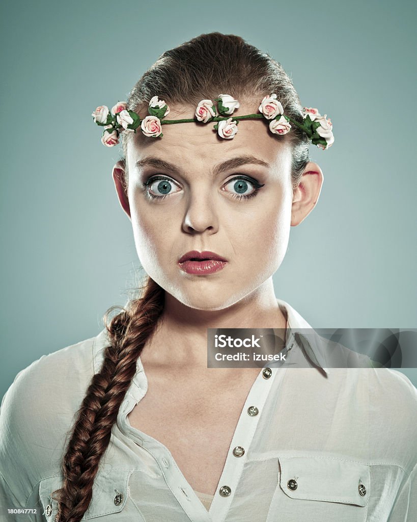 Surprised woman Portrait of surprised young adult woman wearing wreath headdress, looking at the camera. Studio shot. Human Face Stock Photo