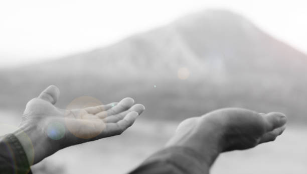 istock Person with open hand  on mountain background in black and white background. 1808477137