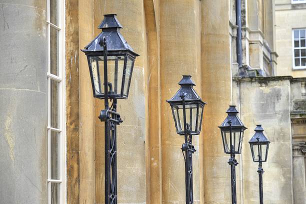 A row of old street lamps in the city of Bath.