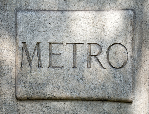 Stone Carved Metro Sign at the Avenue des Champs Elysees in Paris.