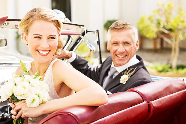 istock Bride And Father Looking Away While Sitting In Car 180848110