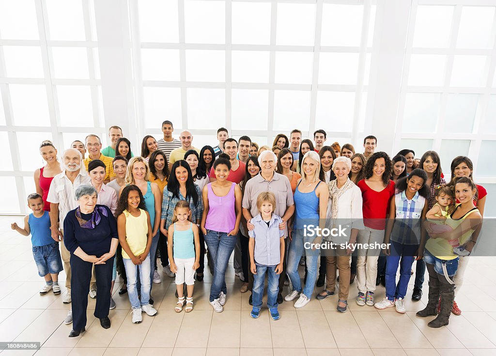 Large group of happy multi-ethnic people. Large group of cheerful mixed age people looking at the camera. 30-39 Years Stock Photo