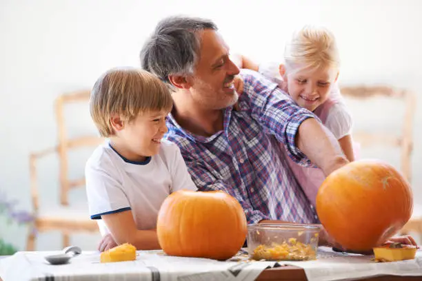 Photo of Goofing off while hollowing the pumpkins