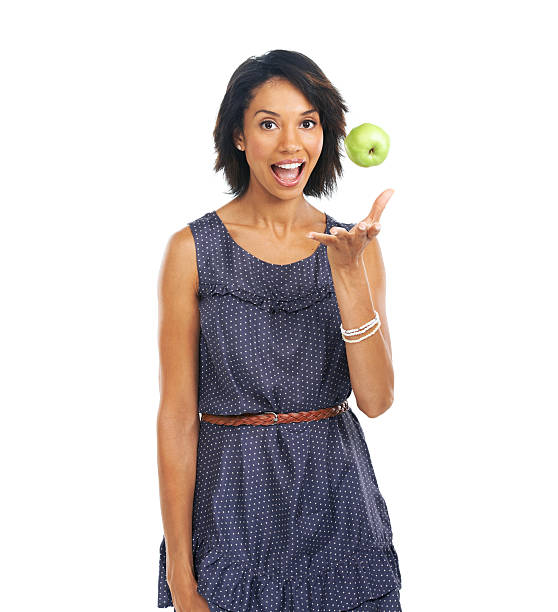 Portrait of a pretty woman throwing an apple