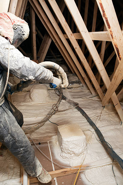 istock Worker Spraying Expandable Foam Insulation in House Attic 180849975