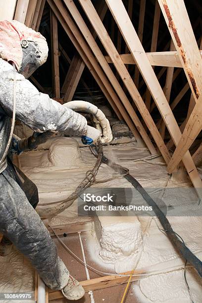 Worker Spraying Expandable Foam Insulation In House Attic Stock Photo - Download Image Now