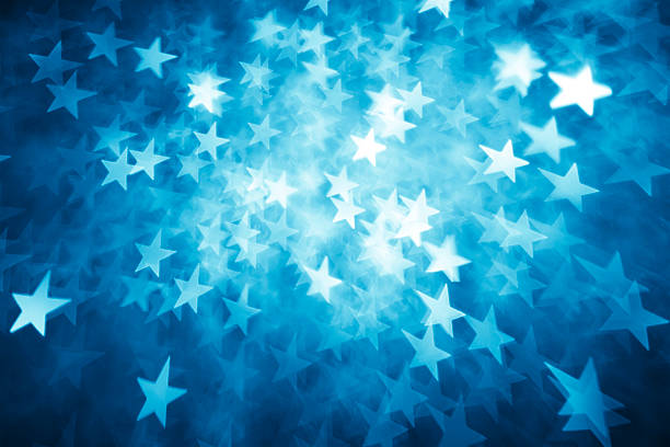 Background of star shaped lights in shades of blue stock photo
