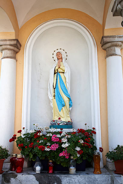 istock Statue of Madonna on church exterior wall 180850607