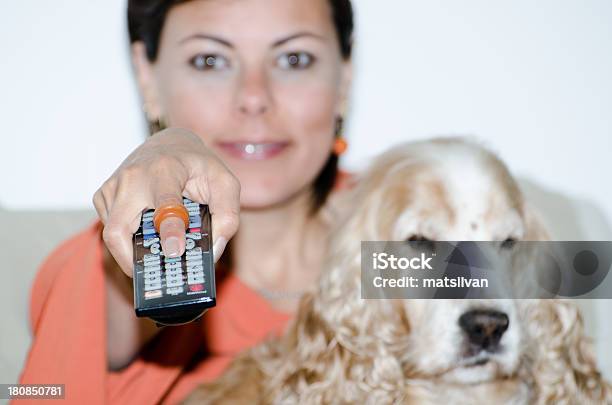 Woman With A Tv Remote Control Stock Photo - Download Image Now - Adult, Adults Only, Animal