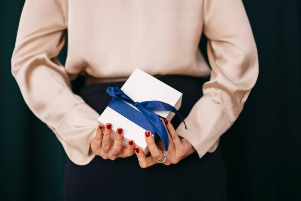 istock Anonymous Woman Hiding a Gift Behind Her Back 1808512775