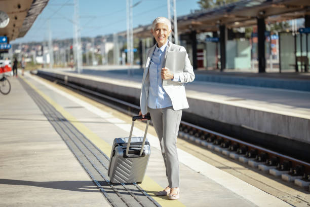istock Female senior commuter at the train station 1808529042