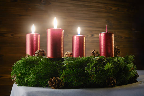 istock For the third Advent, three burning candles on an Advent wreath against a wooden background 1808543669