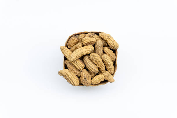 istock cooked peanuts in the bamboo basket isolated on white background,  flat lay. Peanuts are good food for cardiovascular health. Ingredients used in various foods 1808555972