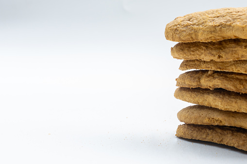 Selective focus of ginger biscuits isolated on white. Stack of ginger biscuits.