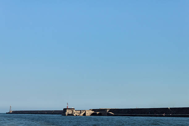 istock Big dock with lighthouse in the distance 180859714